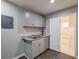 Compact kitchenette featuring modern cabinetry, granite countertop, and open access to bathroom at 1672 Thornton Pl, Atlanta, GA 30315