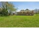 A spacious backyard view featuring lush green grass and the exterior of a brick home at 2792 Toney Dr, Decatur, GA 30032