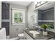 Modern bathroom features a granite vanity, updated fixtures, and shower with gray tiling at 2792 Toney Dr, Decatur, GA 30032