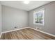 Clean, bright bedroom with wood floors, a large window, and neutral walls at 2792 Toney Dr, Decatur, GA 30032