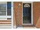 A welcoming front door is framed by classic brickwork and white trim, creating a warm entrance at 2792 Toney Dr, Decatur, GA 30032