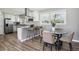 Bright kitchen and dining area with stainless steel appliances, modern cabinetry, and breakfast bar seating at 2792 Toney Dr, Decatur, GA 30032