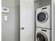 Convenient laundry area with stacked washer and dryer and a nearby control panel at 2792 Toney Dr, Decatur, GA 30032