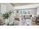Open-concept living and dining area filled with natural light, modern furnishings, and hardwood floors at 2792 Toney Dr, Decatur, GA 30032