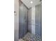 The shower has gray and white tiles, a glass door, and sleek fixtures at 2792 Toney Dr, Decatur, GA 30032