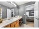 Neutral bathroom features a vanity with wood cabinets and a large countertop and big mirror at 331 Greystone Pkwy, Hiram, GA 30141