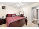 Bedroom with ceiling fan, bed with dark red bedding, and dresser at 331 Greystone Pkwy, Hiram, GA 30141