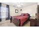 Bedroom with ceiling fan, bed with dark red bedding, and dresser at 331 Greystone Pkwy, Hiram, GA 30141