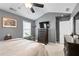 Bedroom featuring dark gray walls, ceiling fan, and a TV on top of a wooden dresser at 331 Greystone Pkwy, Hiram, GA 30141
