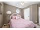 Bedroom with ceiling fan, octagon window, and a bed with pink bedding at 331 Greystone Pkwy, Hiram, GA 30141