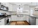 Bright kitchen with stainless steel appliances, undermount sink, tile backsplash, and granite countertops at 331 Greystone Pkwy, Hiram, GA 30141