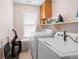 Laundry room showcases a washer, dryer, shelving, and window at 331 Greystone Pkwy, Hiram, GA 30141