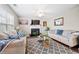 Bright living room featuring a fireplace, ceiling fan, and large window at 331 Greystone Pkwy, Hiram, GA 30141