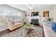 Bright living room featuring a fireplace, ceiling fan, and large window at 331 Greystone Pkwy, Hiram, GA 30141
