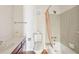 Bathroom showcasing a toilet, sink, shower, and neutral tile at 6700 Roswell Rd # 14C, Atlanta, GA 30328