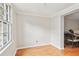 Bright, empty room features hardwood floors, white trim, and natural light streaming through a large window at 6700 Roswell Rd # 14C, Atlanta, GA 30328