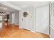 Inviting entryway featuring gleaming hardwood floors, decorative wreath on front door, and closet at 6700 Roswell Rd # 14C, Atlanta, GA 30328