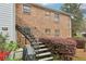 Back exterior of home, featuring staircase, shrubs, and brick wall at 6700 Roswell Rd # 14C, Atlanta, GA 30328