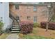 Home exterior featuring brick facade, metal staircase, and natural surroundings at 6700 Roswell Rd # 14C, Atlanta, GA 30328