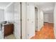 Hallway view showing hardwood floors, white doors, and a view into multiple rooms at 6700 Roswell Rd # 14C, Atlanta, GA 30328