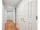 Hallway featuring hardwood floors, multiple white doors and recessed lighting at 6700 Roswell Rd # 14C, Atlanta, GA 30328