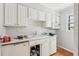 White kitchen featuring cabinets, counters, and a window providing natural light at 6700 Roswell Rd # 14C, Atlanta, GA 30328