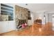 Cozy living room with a stone fireplace, built-in shelving, and hardwood floors, creating a warm and inviting space at 6700 Roswell Rd # 14C, Atlanta, GA 30328