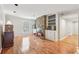Spacious living room featuring stone fireplace, built-in shelves, and gleaming hardwood floors at 6700 Roswell Rd # 14C, Atlanta, GA 30328