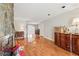 Open living room featuring a stone fireplace, hardwood floors, and seamless transition into the dining area at 6700 Roswell Rd # 14C, Atlanta, GA 30328