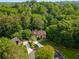 Aerial view of a home nestled among mature trees at 275 Tynebrae Pl, Roswell, GA 30075