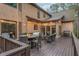 Expansive back deck featuring an outdoor kitchen, dining, fire pit, and lounge areas with ambient string lights at 275 Tynebrae Pl, Roswell, GA 30075