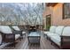 Inviting outdoor space featuring a fire pit, seating, and wooded views from the beautifully furnished back deck at 275 Tynebrae Pl, Roswell, GA 30075