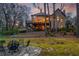 Backyard featuring a large deck, stone patio, and landscaped yard, ideal for outdoor entertaining at 275 Tynebrae Pl, Roswell, GA 30075