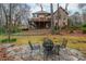 Beautiful backyard features a stone patio and comfortable seating at 275 Tynebrae Pl, Roswell, GA 30075