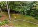 Lush, expansive backyard with mature trees, a gently flowing creek, and a serene atmosphere, offering a tranquil outdoor retreat at 275 Tynebrae Pl, Roswell, GA 30075
