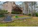 Sprawling backyard with a retaining wall, mature trees, and a multi-level deck on the home at 275 Tynebrae Pl, Roswell, GA 30075