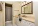 Traditional bathroom with framed mirror, neutral vanity, and patterned wallpaper for a relaxing, comforting feel at 275 Tynebrae Pl, Roswell, GA 30075