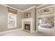 Bedroom with a cozy fireplace, a window, and an en suite Primary bathroom at 275 Tynebrae Pl, Roswell, GA 30075