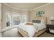 Comfortable bedroom with neutral tones, plush carpet, and a large bay window overlooking the backyard deck at 275 Tynebrae Pl, Roswell, GA 30075