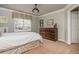 Bedroom features a plush bed, a window with valance, a dark wood dresser, and carpet at 275 Tynebrae Pl, Roswell, GA 30075