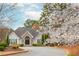 Community clubhouse with stone accents, well-maintained landscaping, and a circular driveway at 275 Tynebrae Pl, Roswell, GA 30075