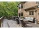 A sprawling deck with a lounge area, dining table, a heater, and verdant trees enhancing its charm at 275 Tynebrae Pl, Roswell, GA 30075