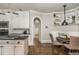 Charming dining nook with a built-in bench, custom shelves, and views towards the kitchen and entry hall at 275 Tynebrae Pl, Roswell, GA 30075