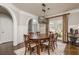 Charming dining room boasts wainscoting, hardwood floors, a modern light fixture, and is next to the entry foyer at 275 Tynebrae Pl, Roswell, GA 30075