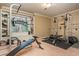 Exercise room features gym equipment, neutral paint, a large window, and carpet at 275 Tynebrae Pl, Roswell, GA 30075