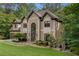 Elegant home with a three-car garage, manicured landscaping, and a grand entrance with a soaring window at 275 Tynebrae Pl, Roswell, GA 30075