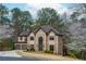 Beautiful home with a three-car garage, manicured landscaping, and a grand entrance with a soaring window at 275 Tynebrae Pl, Roswell, GA 30075