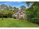 Stately home with a three-car garage, manicured landscaping, and a grand entrance with a soaring window at 275 Tynebrae Pl, Roswell, GA 30075