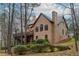 Stucco two-story home with a spacious wooden deck and manicured landscaping at 275 Tynebrae Pl, Roswell, GA 30075