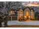 Elegant home with a three-car garage, manicured landscaping, and a grand entrance with a soaring window at 275 Tynebrae Pl, Roswell, GA 30075